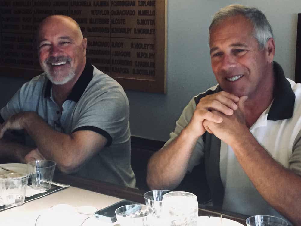 two-men-smiling-sitting-at-bar