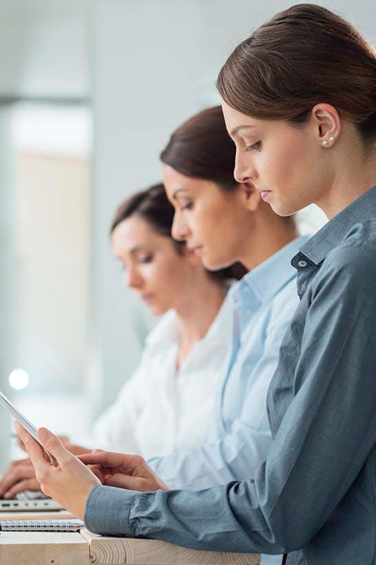 three-brunette-women-working-at-desk-westport-ma