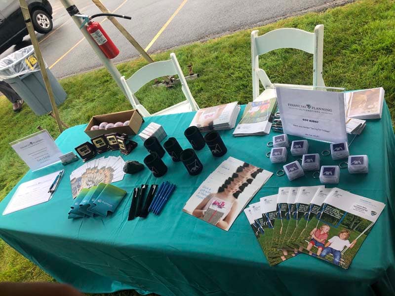 table-with-brochures-and-branded-swag